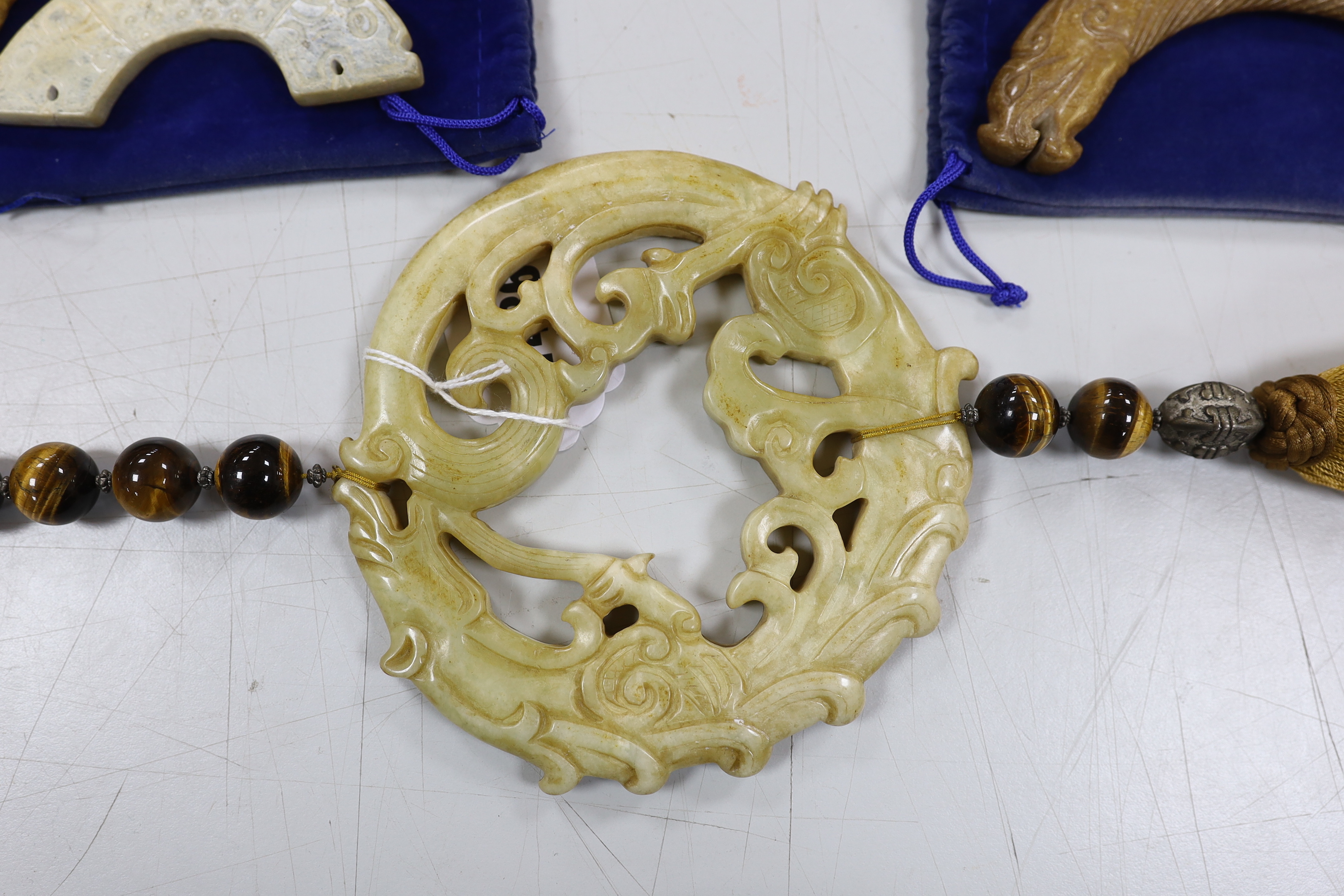 Three Chinese jade carvings, two huang, a large hardstone pendant and disc, largest overall 90cm in length (4)